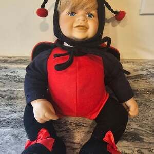 Vintage Porcelain Baby Doll in Ladybug Outfit, Blue Eyes, Blond Hair